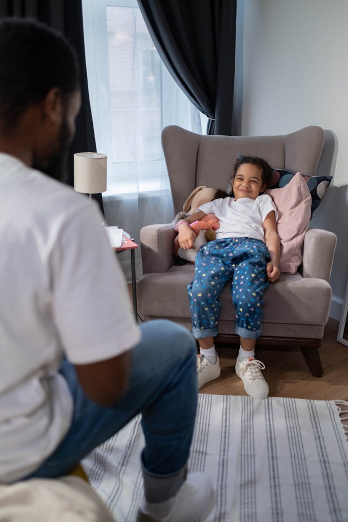 A joyful father-daughter moment in a cozy living room with bright natural light.